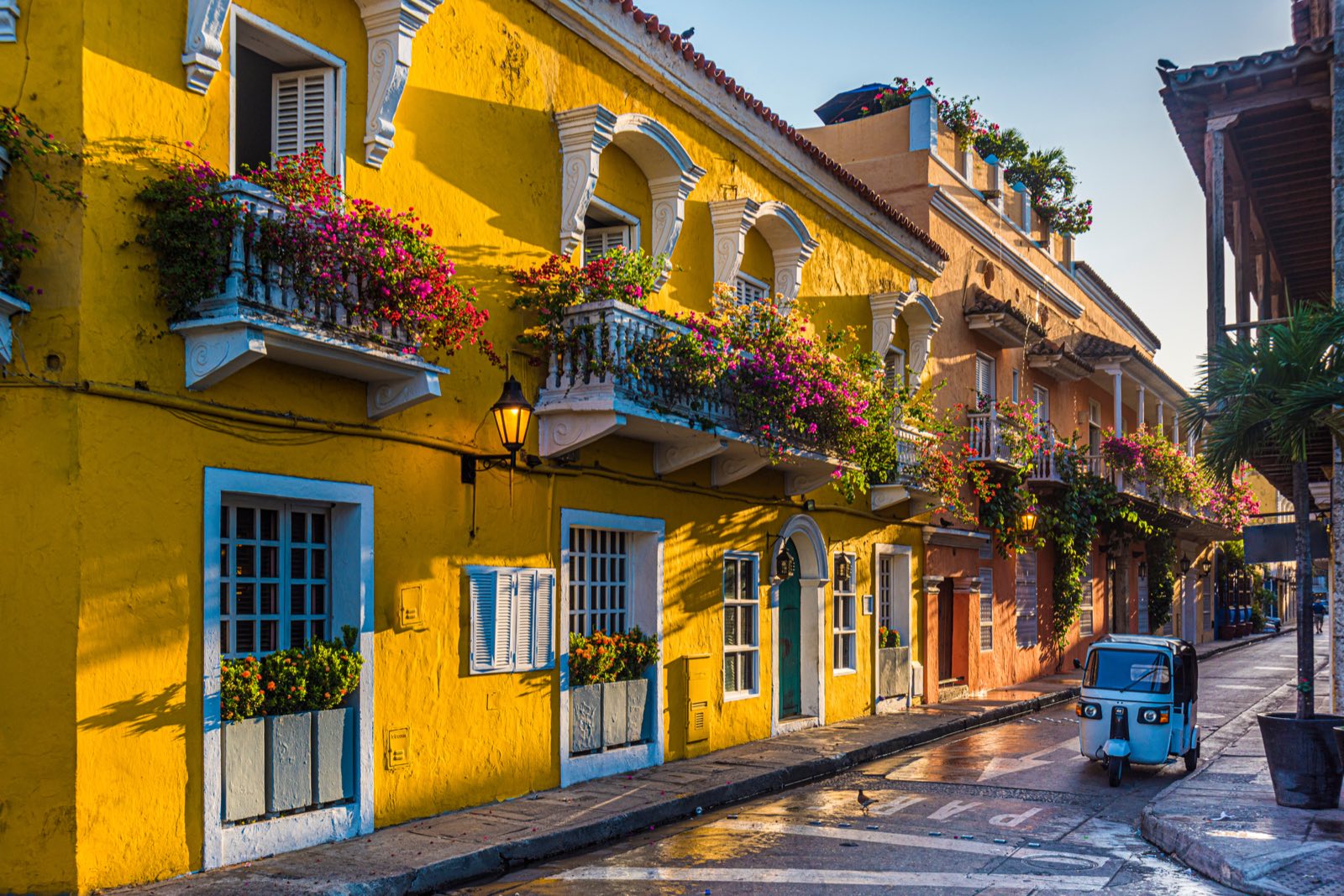 Colourful houses with flowered balconies in a sunny street